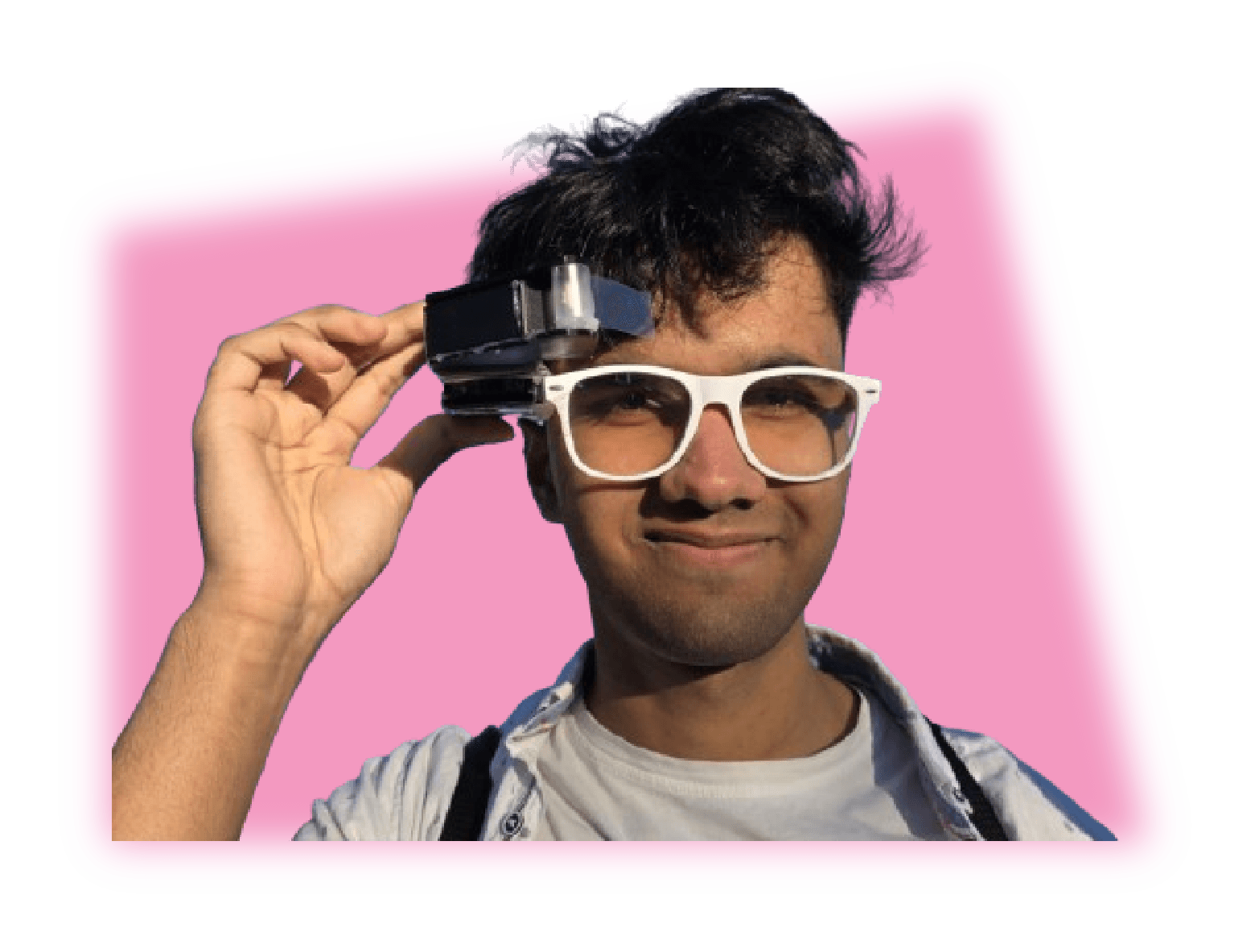 Abhik holding a camera module mounted on a pair of glasses